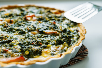open spinach pie in baking dish