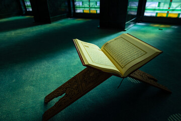 Ramadan or islamic background photo. The Holy Quran on the book stand