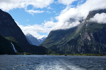 boats in fjords of milford sound, new zealand