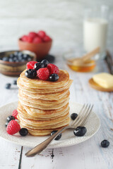 Pancakes with berries in rustic style	