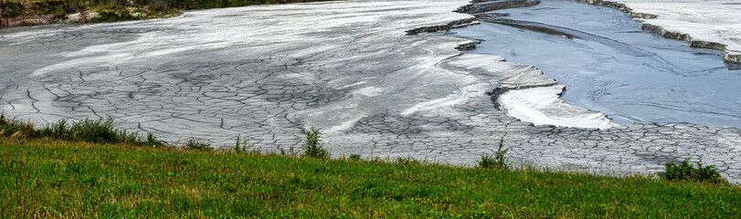 Shore of toxic  lake in abandoned open pit copper mine.