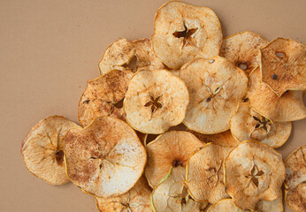 Dried apple and pear slices on a beige background