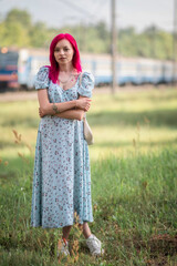 Portrait of a young beautiful girl with red hair in an urban environment.