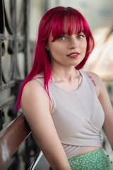 Portrait of a young beautiful girl with red hair in an urban environment.