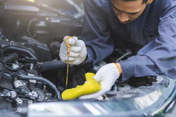 Auto check, car service shop concept. Automobile repairman work checking change engine oil,...