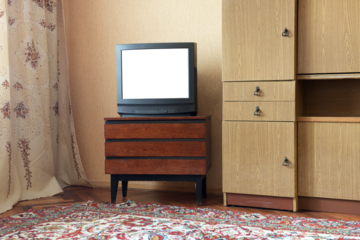 Antique TV with white screen on antique wooden cabinet, vintage design in 80s and 90s style house.