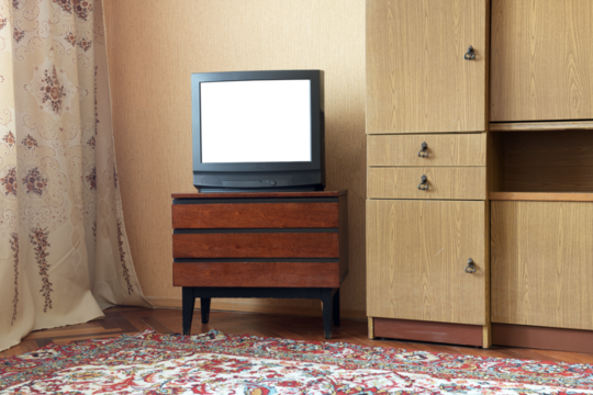 Antique TV with white screen on antique wooden cabinet, vintage design in 80s and 90s style house.