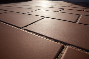 tiled floor, close-up of reddish tiles, geometric lines
