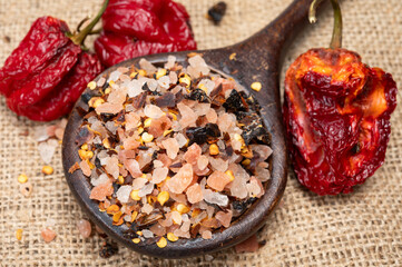 Pink himalayan salt chrystals with dried seeds of red hot chili peppers and herbs, cooking with exotic salt
