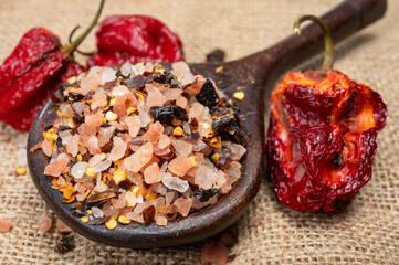 Pink himalayan salt chrystals with dried seeds of red hot chili peppers and herbs, cooking with exotic salt