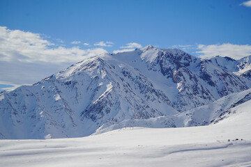 Fototapeta na wymiar Scenic view of a snow-covered mountain on a beautiful winter day. Andes mountain range, Chile.