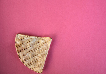 corn tortilla chips isolated on a pink red background (cut out masa chip for dipping) restaurant style crunchy toasted yellow, white nixtamalized hominy (mexican food, totopos)