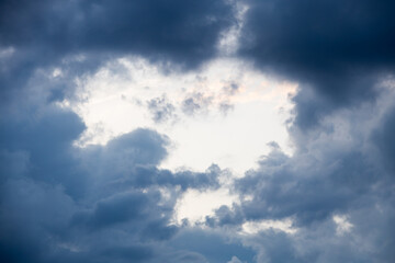 Fototapeta na wymiar Hole in clouds - stormy weather background