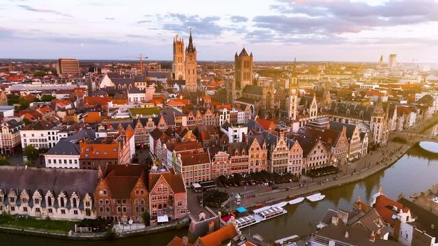Aerial view of famous places Castle of the Counts next to river Lys. Beautiful architecture and landmarks of the medieval city on a sunset. Ghent, Belgium