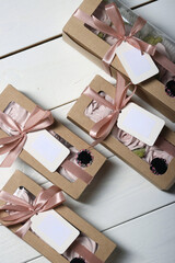 Four boxes of homemade marshmallows. Marshmallow flowers. Craft packaging tied with ribbon. Labels...