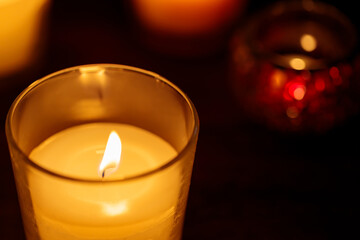 Yellow Candle Burning on Dark Background, Copy Space