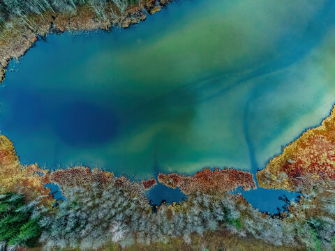 Aerial view of the lake in Lithuanian forests, wild autumn nature. Name of the lake "Versminis", Dzukija National Park, Europe