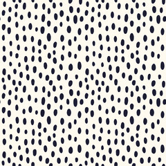 abstract dots of different sizes are scattered on a seamless background in a chaotic manner. dots and spots print for fashion fabric