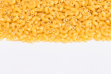 Uncooked Chifferi Rigati Pasta Scattered on White Table. Fat and Unhealthy Food. Classic Dry Macaroni. Italian Culture and Cuisine. Raw Pasta