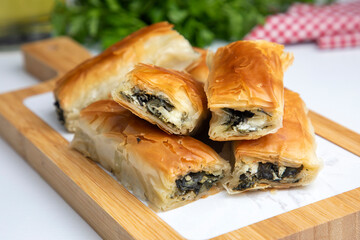 Handmade Spinach Cheese Pie - pastry, Turkish name; el acmasi borek, rulo borek. Turkish borek rolls with spinach and cheese. A traditional Turkish pastry rulo borek - obrazy, fototapety, plakaty