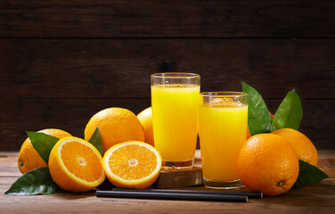 glasses of fresh orange juice with fresh fruits