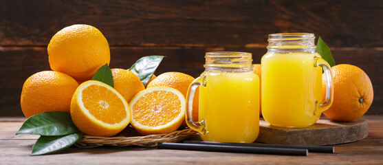 Jar glasses of fresh orange juice with fresh fruits