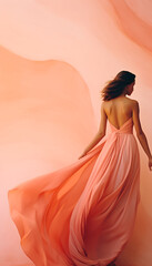 Beautiful women in long pastel orange colored dress