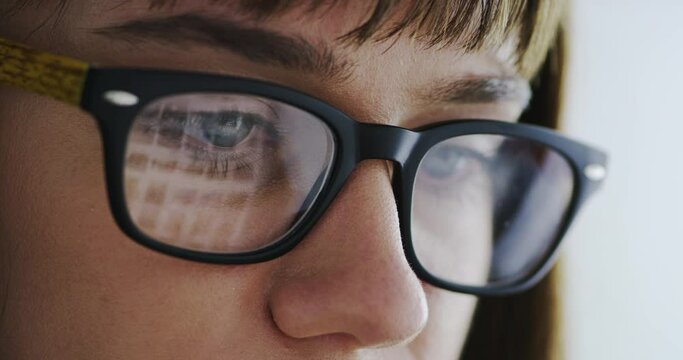 Woman, glasses and screen reflection in closeup for reading, optometry and wellness for eyesight at job. Girl, lens and frame for healthy eyes, ophthalmology and thinking with vision, ideas or search
