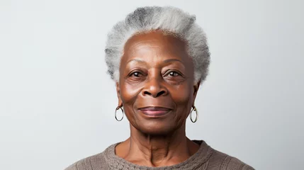 Fotobehang Close-up portrait of mature old black woman with short haircut isolated on white background, african-american lady with gray hair smiling. Copy space. AI generated  © SkyLine