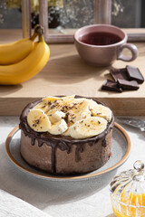Cake with chocolate drips and bananas on top