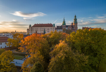 Wawel castle and cathedral over colorful autumn park in the morning sun, Krakow, Poland