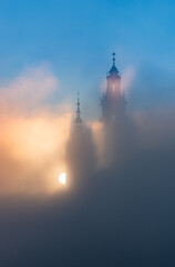 Krakow, Poland, Wawel cathedral towers shrouded in the fog, sunlit in the morning