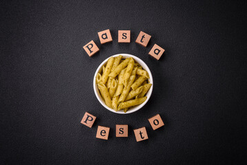 Delicious fresh pasta penne with green pesto sauce with basil, salt and spices