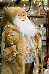 Santa Claus in a golden fur coat and with a golden Christmas tree