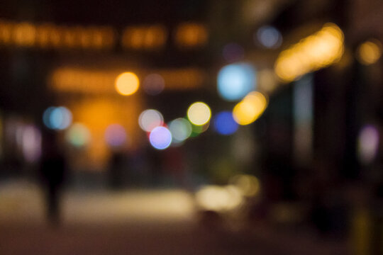 city street at night. blurred festive urban background with bokeh effect