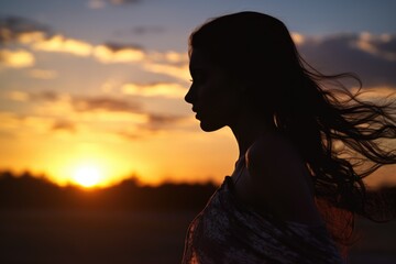 A captivating image of a woman with long hair in a stunning silhouette against a vibrant sunset backdrop. Perfect for adding a touch of elegance and beauty to any project. - obrazy, fototapety, plakaty