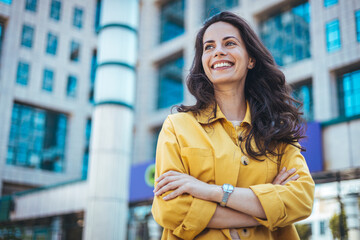 Portrait of a beautiful happy woman outdoors. Smiling woman in the city. Candid portrait of a...