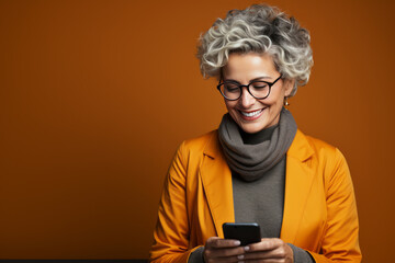 Adult woman with a phone. In yellow and orange clothes.