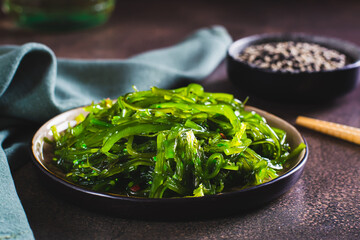 Traditional fresh seaweed and sesame salad on a plate on the table