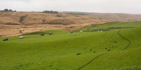 Fototapeta na wymiar 4WD vehicles in convoy cross high country farmland in New Zealand