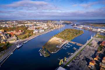 Szczecin from a bird's eye view on a sunny day. View of the city from the Oder River. City buildings, the seaport in Szczecin and its most characteristic places. © Olivier Uchmanski