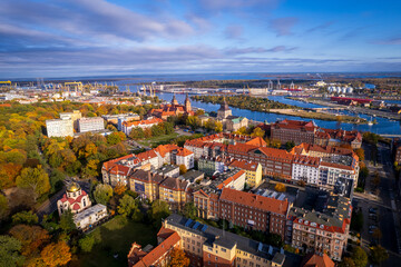 Fototapeta na wymiar Szczecin from a bird's eye view on a sunny day. View of the city from the Oder River. City buildings, the seaport in Szczecin and its most characteristic places.
