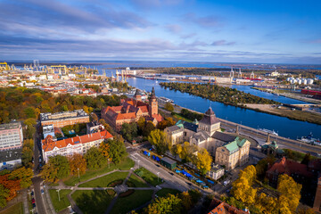 Szczecin from a bird's eye view on a sunny day. View of the city from the Oder River. City buildings, the seaport in Szczecin and its most characteristic places.