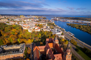 Szczecin from a bird's eye view on a sunny day. View of the city from the Oder River. City buildings, the seaport in Szczecin and its most characteristic places.