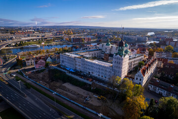 Szczecin from a bird's eye view on a sunny day. View of the city from the Oder River. City buildings, the seaport in Szczecin and its most characteristic places.