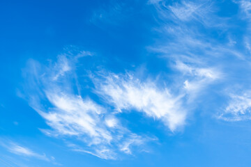 Blue clear sky with white cirrus spindrift clouds background panorama. Natural abstraction.