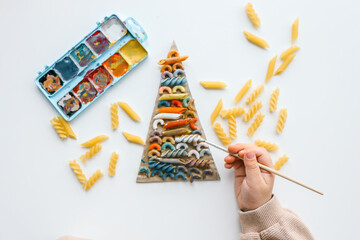 Sensory creative activity for children, child coloring pasta