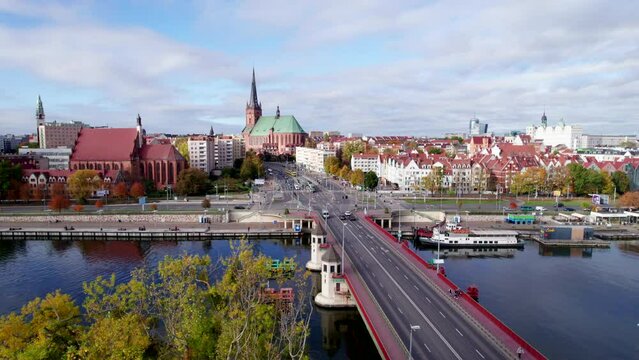 Szczecin from a bird's eye view on a sunny day. View of the city from the Oder River. City buildings, the seaport in Szczecin and its most characteristic places.