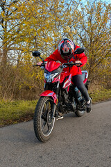 Fototapeta na wymiar biker girl in red. red motorcycle.