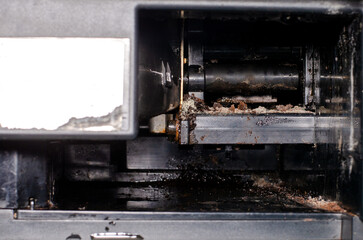 Disassembled coffee machine with coffee remains